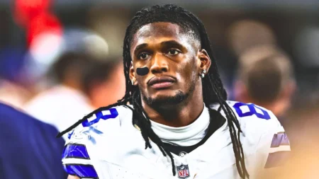 CeeDee Lamb #88 of the Dallas Cowboys looks on from the sideline during an NFL football game against the Houston Texans at AT&T Stadium.
